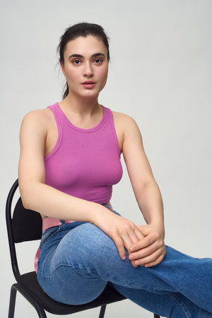 Confident young woman sitting on chair