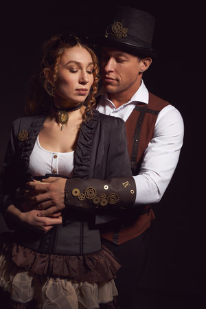 Stylish ethnic couple embracing in studio and looking at lightの写真素材