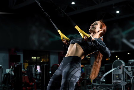 Happy brunette exercising in a gym shotの写真素材