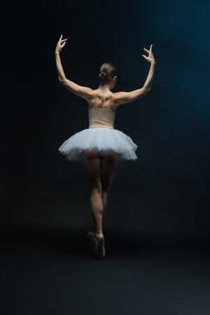 Beautiful ballet dancer showcasing posture in elegant white tutuの写真素材