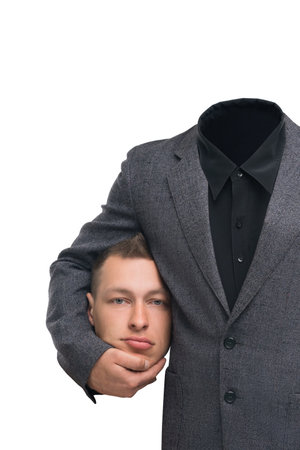Unique artistic representation of a man with a missing head in stylish suitの写真素材