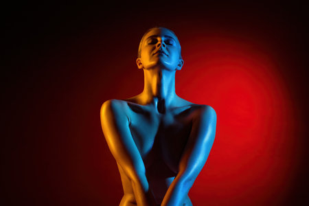 Artistic portrayal of a model with colorful lighting at a studioの写真素材