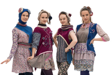 Traditional fashion showcase featuring four women in unique costumes