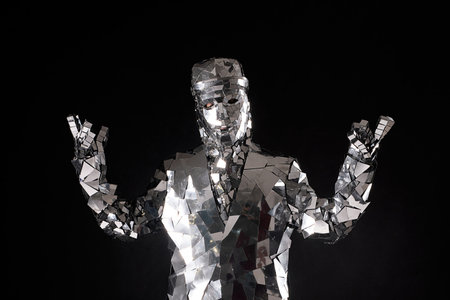 Reflective performer in a mirrored costume striking a pose on stageの写真素材
