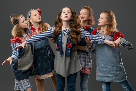 Group of young girls posing creatively in stylish outfitsの写真素材