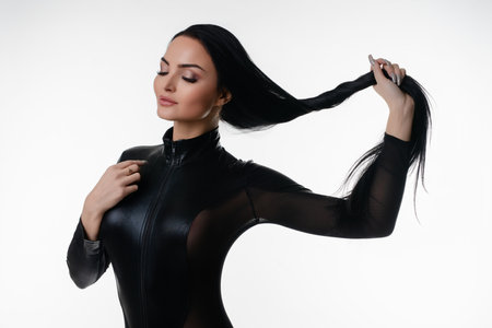 Elegant woman in lingerie poses gracefully in a studio settingの写真素材