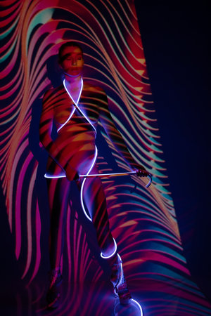 Artistic expression of beauty using light and projection on a human figureの写真素材