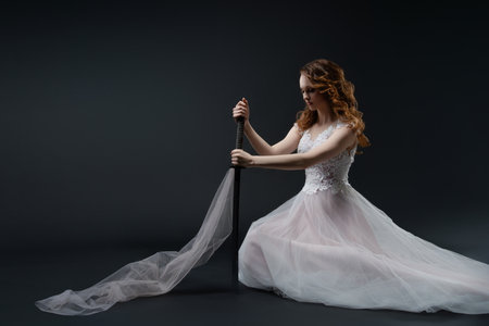 Woman in lingerie poses elegantly with flowing fabric in the studioの写真素材