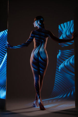 Light and shadow interplay with a figure in captivating projectionsの写真素材