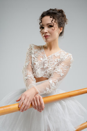 Elegant ballet dancer showcases grace and beauty in a serene studio settingの写真素材