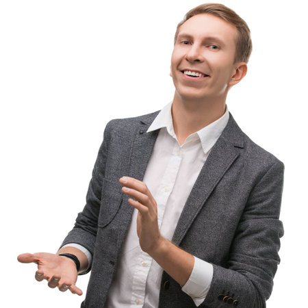 Smiling man in suit offering presentation with confident body languageの写真素材