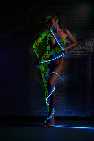 Slim woman with LED strip around bodyの写真素材