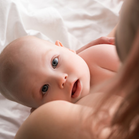 Baby gazes lovingly at mother during bonding time in serene settingの写真素材