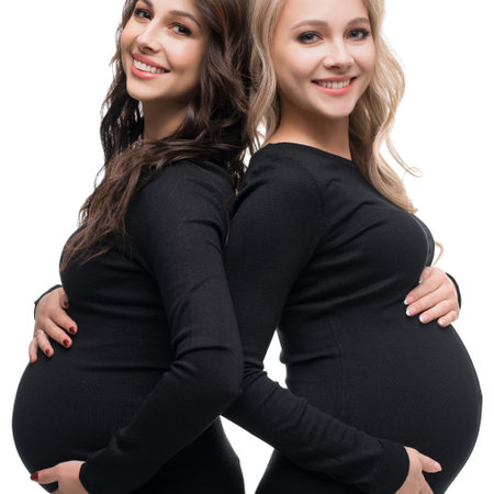 Joyful moments shared between two expectant mothers celebrating friendshipの写真素材