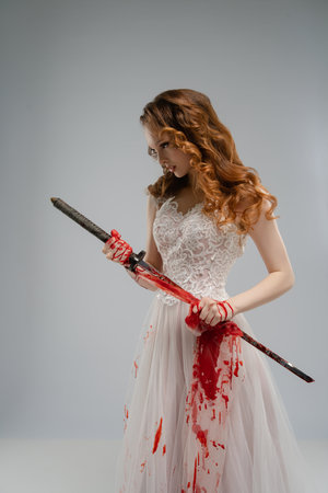 Bridal gown-clad woman wields bloodied katana, mixing beauty and violenceの写真素材