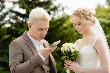 Couple exchanging heartfelt vows during their outdoor wedding ceremonyの写真素材