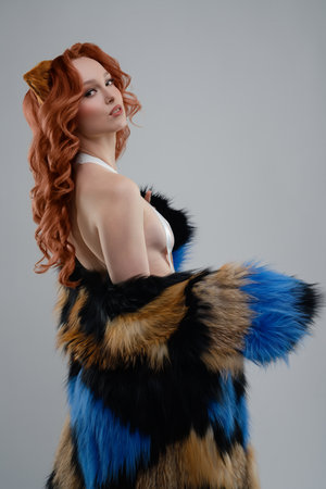 Creative body art and fur fashion presented by a model in a studio settingの写真素材
