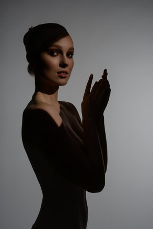 Woman showcasing beauty and grace in artistic silhouetteの写真素材