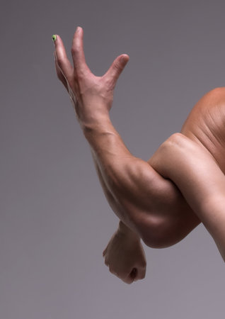 Unusual arm positioning creates striking visual contrast in human anatomyの写真素材