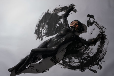 Woman adorned with body art lies gracefully on a canvasの写真素材