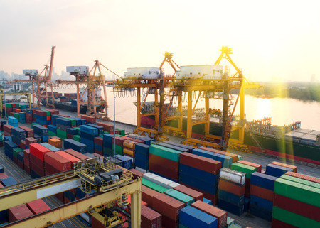 Aerial view of a trade port with container ship in import export and business logistic.