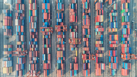 Container ship in export and import business and logistics. Shipping cargo to harbor by crane. Water...