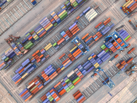 Container ship in export and import business and logistics. Shipping cargo to harbor by crane. Water...