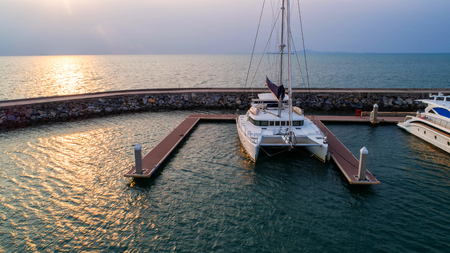 Pier speedboat. A marina lot. This is usually the most popular tourist attractions on the beach.Yacht and sailboat is moored at the quay.Aerial view by drone.Top view.の写真素材