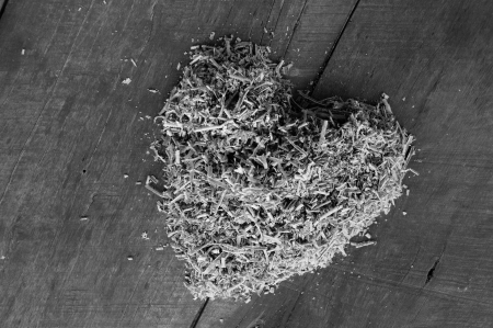 heart shape of sawdust on wooden floorの写真素材