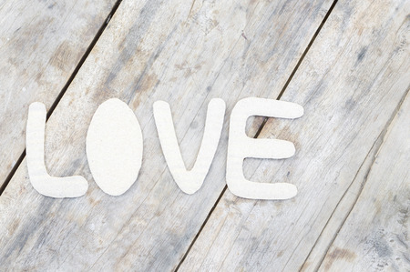 paper word love on wood backgroundの写真素材