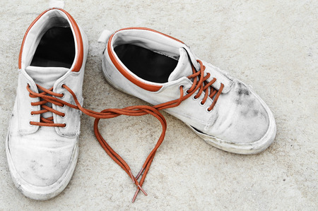 shoelace heart shape of old dirty sneakerの写真素材