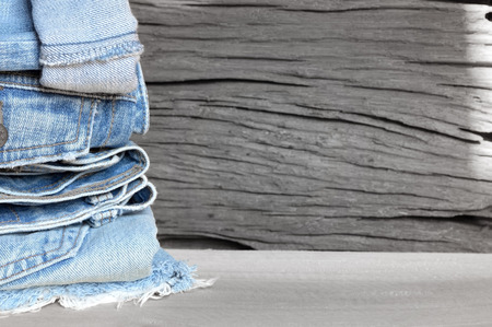 lot of different blue jeans on wooden backgroundの写真素材