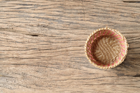 top view of wicker basket on old wooden tableの写真素材