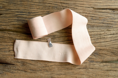 elastic bandage on wooden backgroundの写真素材