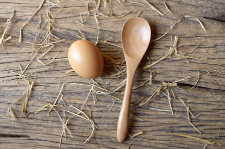 egg with spoon on wooden backgroundの写真素材