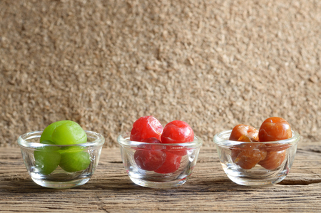 mix pickle cherry fruit in glass bowl on wooden tableの写真素材