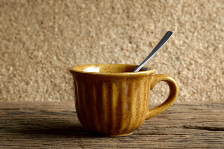 brown coffee cup on old wooden tableの写真素材
