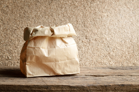 brown paper bag on wooden backgroundの写真素材