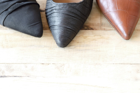top view of different woman shoe on wooden background, several types of high heelsの写真素材