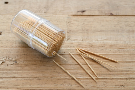 wooden toothpick in plastic box on wood table, for cleaning teethの写真素材