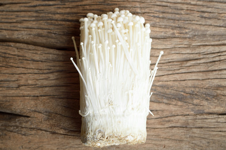 top view of Golden mushroom or Enoki mushroom on wooden table