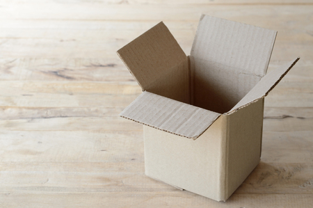 open cardboard box on wooden table