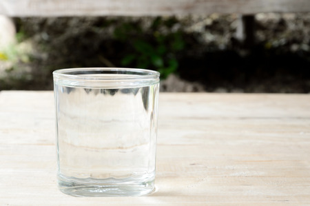 glass of purified water on wooden tableの写真素材