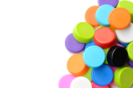 pile of colorful plastic bottle cap isolated on white backgroundの写真素材