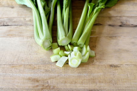choy sum vegetable on wooden table backgroundの写真素材