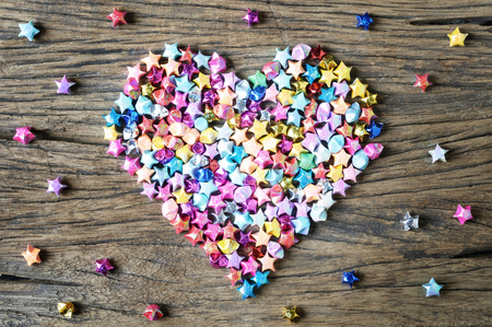 heart shape from origami star on wooden background, valentine's backgroundの写真素材