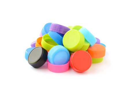 pile of colorful plastic bottle cap isolated on white backgroundの写真素材