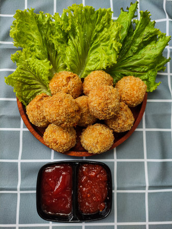 Brulee Bomb or Bitterballen, homemade snack from smoked beef, carrot, milk, flour, cheese, filled with mozzarella. Breaded and deep fried. Selective focusの写真素材