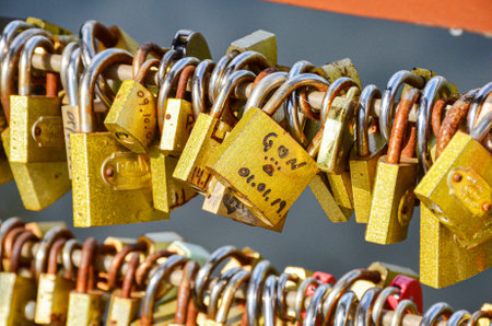 Love locks on the Love Deck (Deck do Amor) in Vitoria Regia Lake, Holambra. Attached by couples in love to symbolize unbreakable loveの写真素材