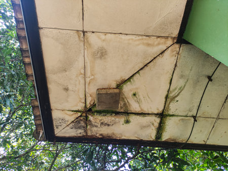 Water damaged ceiling roof in an old house. Ceiling exterior broken